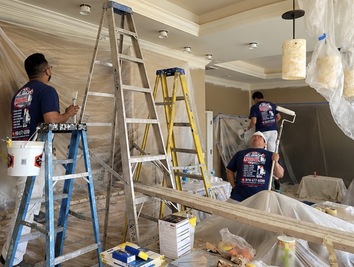Furniture masked and protected before a full-room repaint
